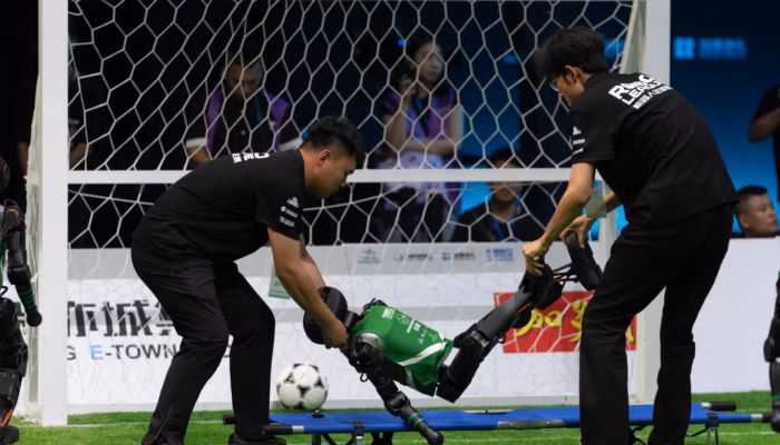 Humanoid Robots Play Soccer Autonomously
